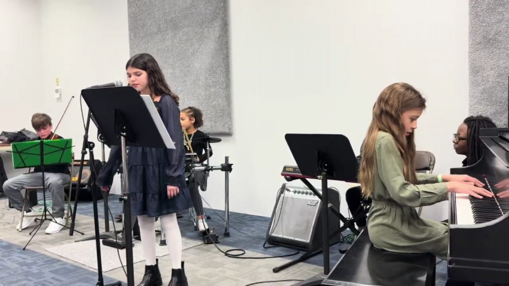 Children ages 6-12 playing instruments in a recital at Chambers Music Studio in Columbus, Ohio.