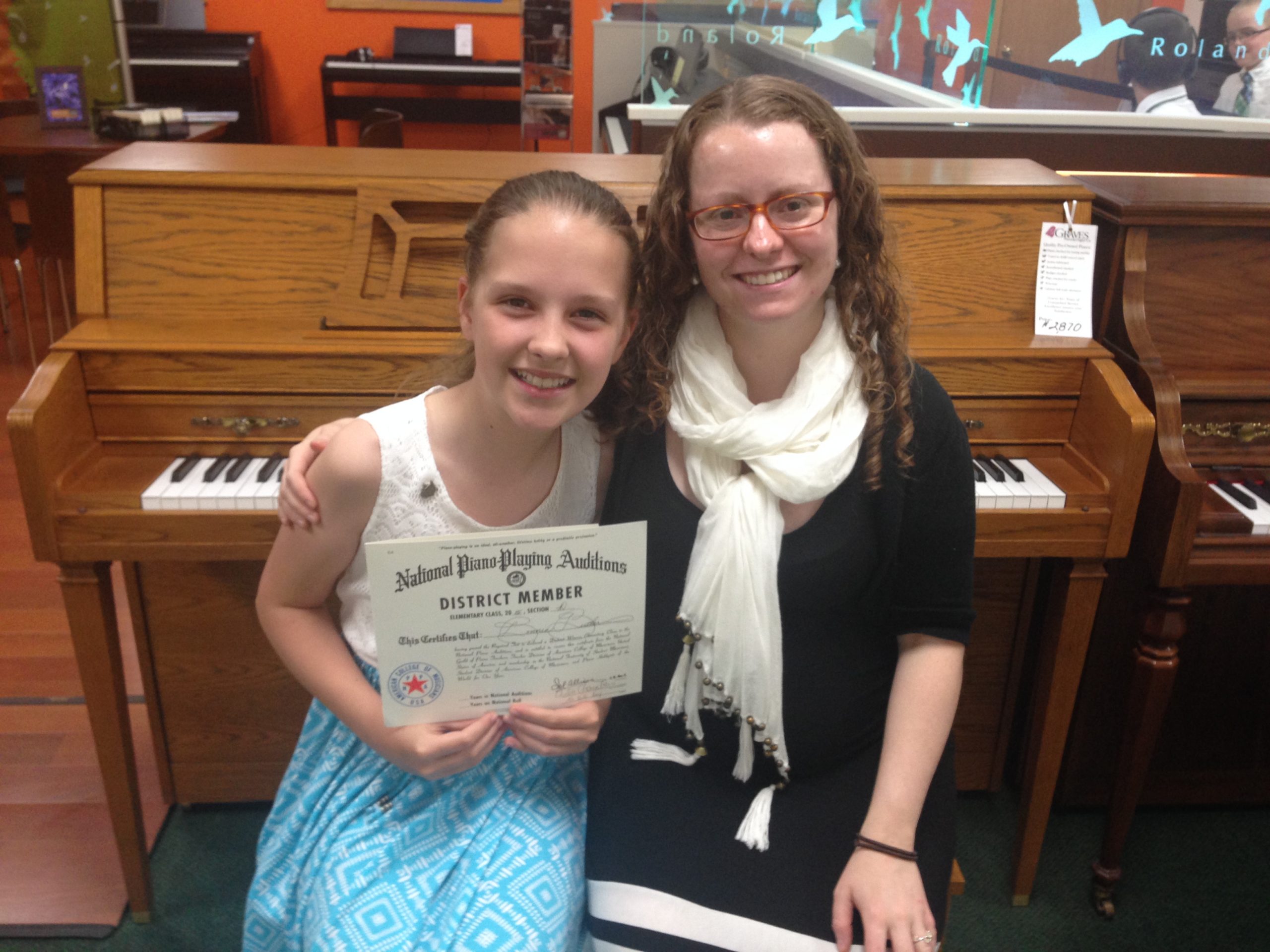 Julie Chambers working with a piano student during private piano lessons at Chambers Music Studio in Columbus, Ohio, creating a warm and supportive learning environment.