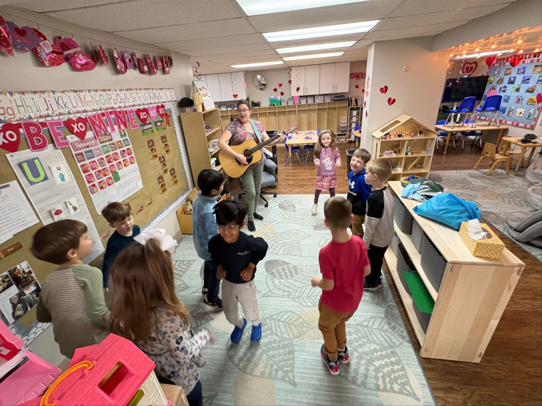 Jen teaching a class while playing guitar Jen teaching a class while playing guitar