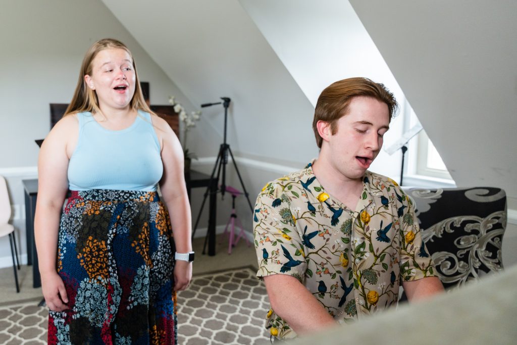 Voice teacher helping a student practice healthy singing technique in Columbus, Ohio.