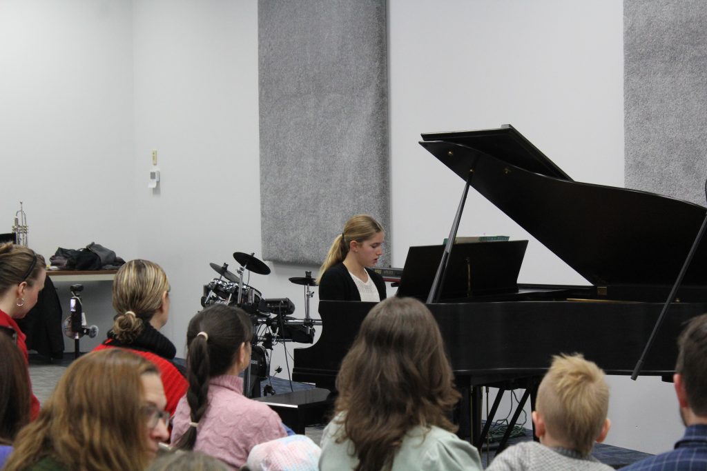 Young musician performing confidently at a Columbus Ohio music recital.