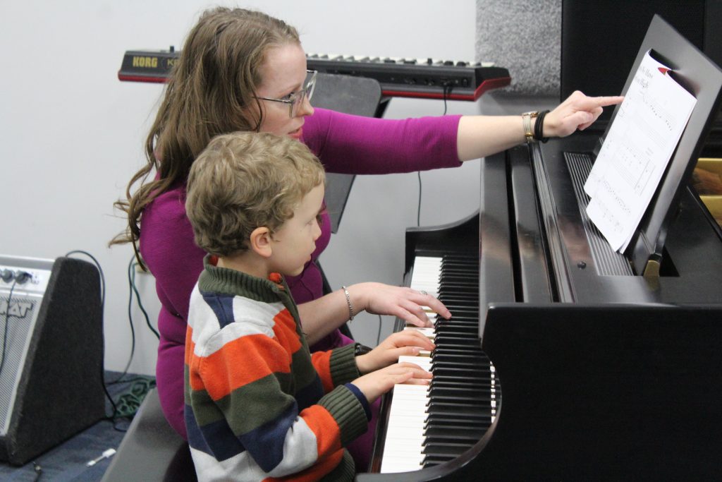 Julie Chambers observing a student during an educational music assessment at Chambers Music Studio in Columbus, Ohio.