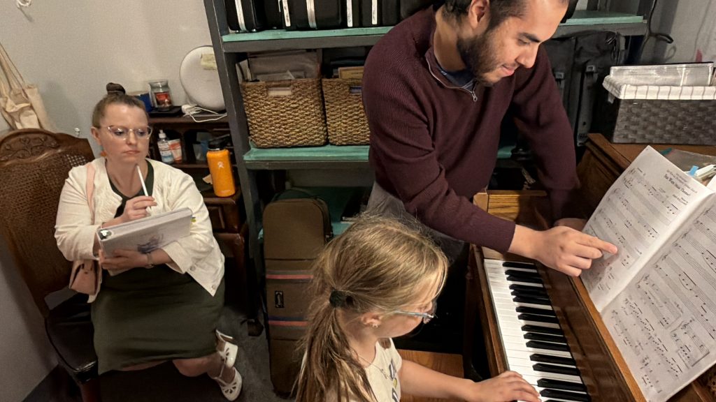 Young musician building confidence while performing for a small audience during a lesson