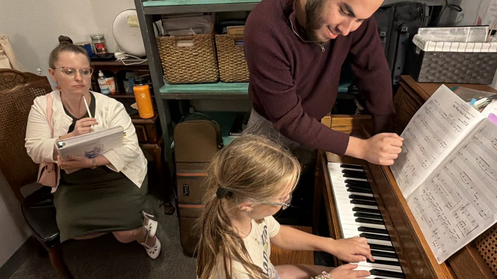 Student musician receiving constructive feedback while working on a piece during a Master Class.
