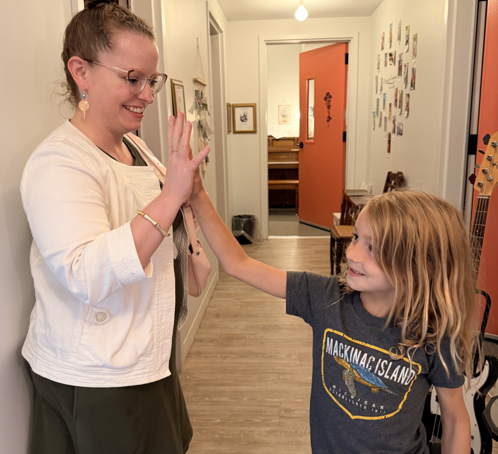 Julie Chambers encouraging a music student during performance preparation in Columbus, Ohio.