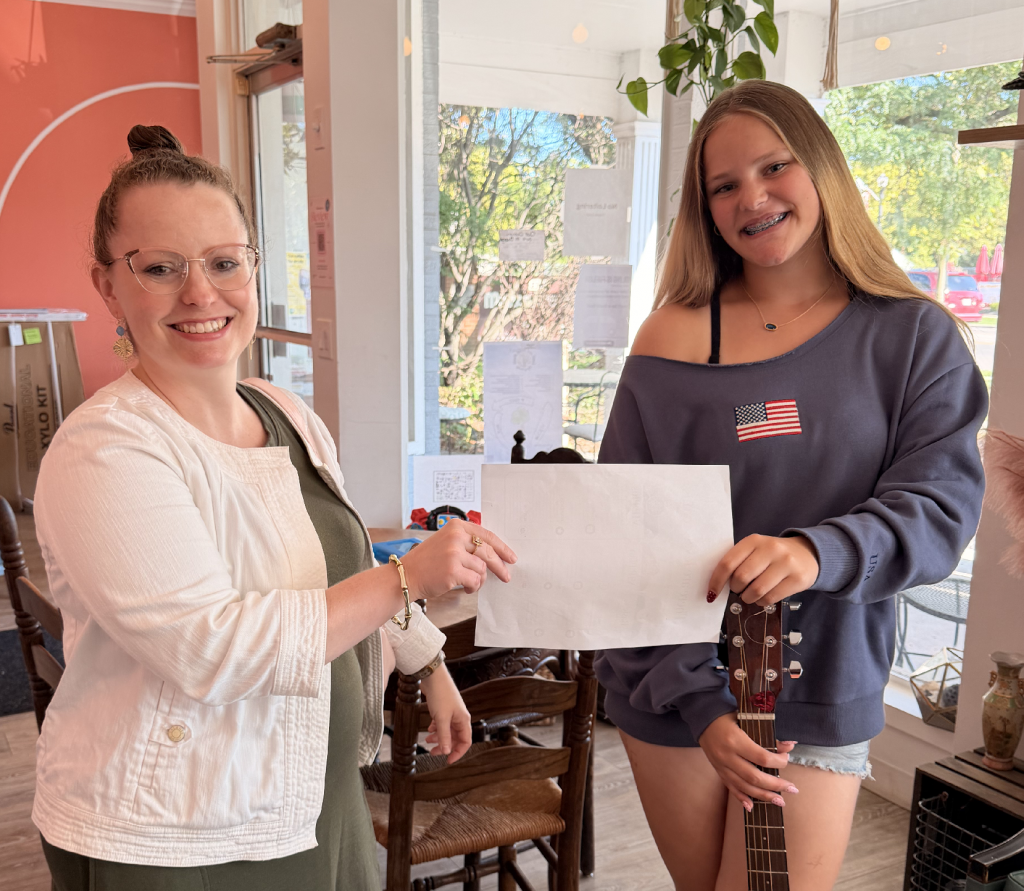 Student musician receiving recognition after completing a professional music assessment.