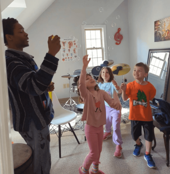 Young children participating in a Jam Band music class in Columbus, Ohio, using rhythm instruments.