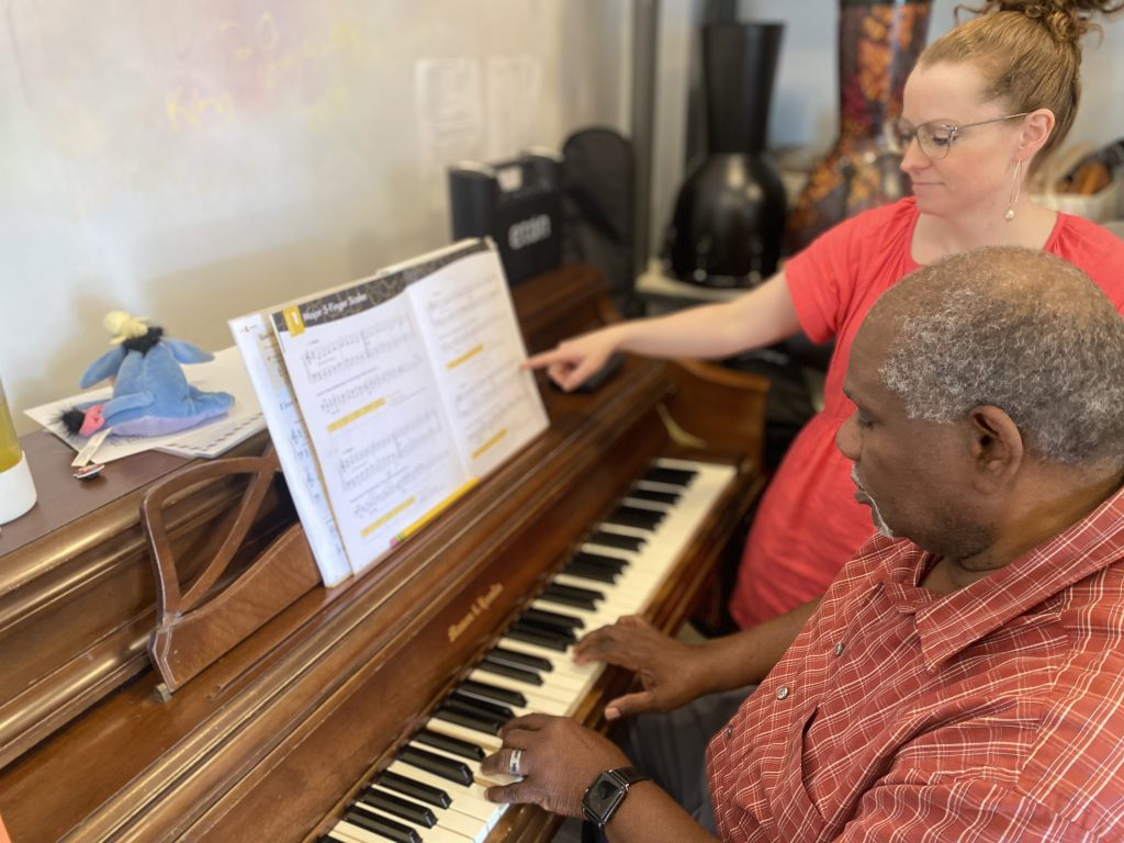 Adult learning piano and developing memory, coordination and concentration through music lessons