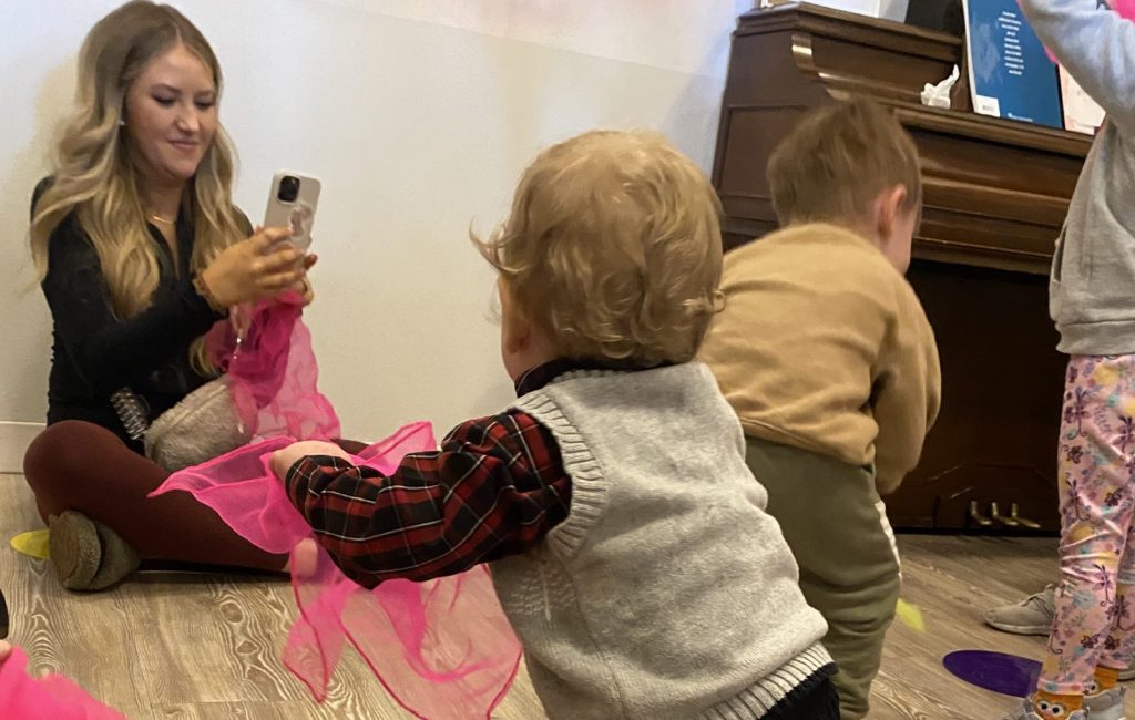 Toddlers enjoy dancing with scarves in mommy and me music time classes in Columbus, Ohio.