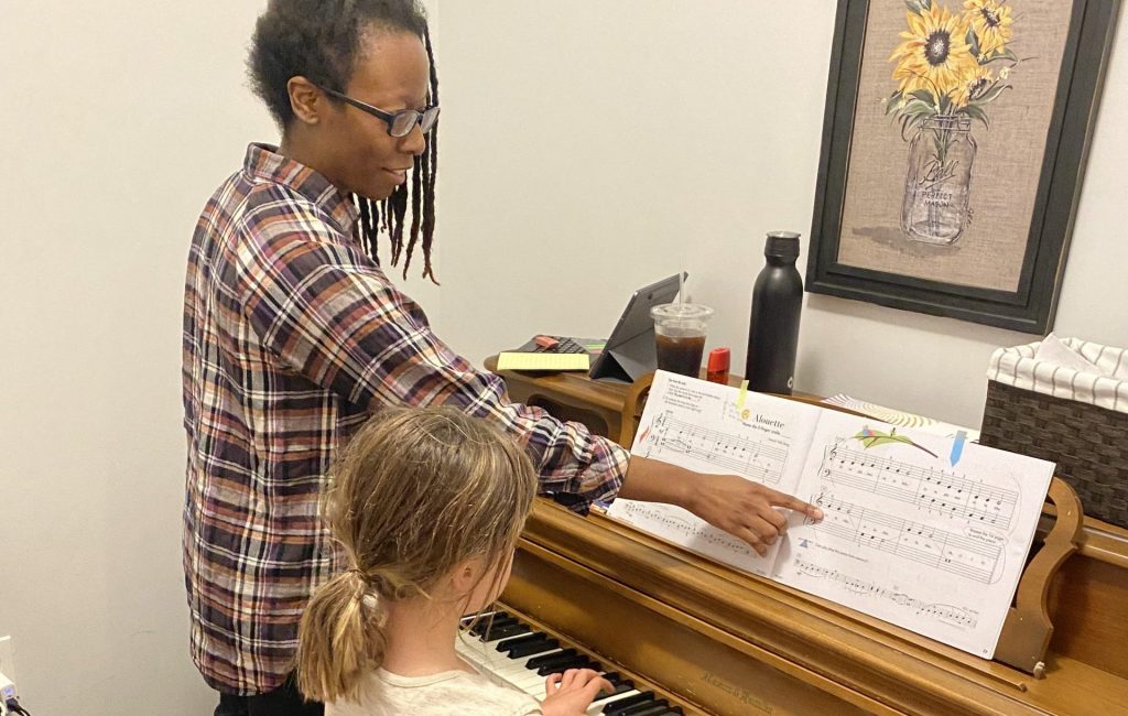 Piano teacher supporting a piano students musical journey through structured education.