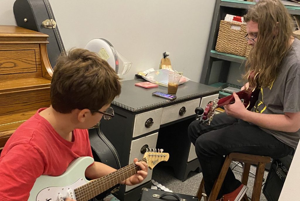 Guitar teacher and student playing guitar songs in their guitar lessons in Bexley, Ohio.