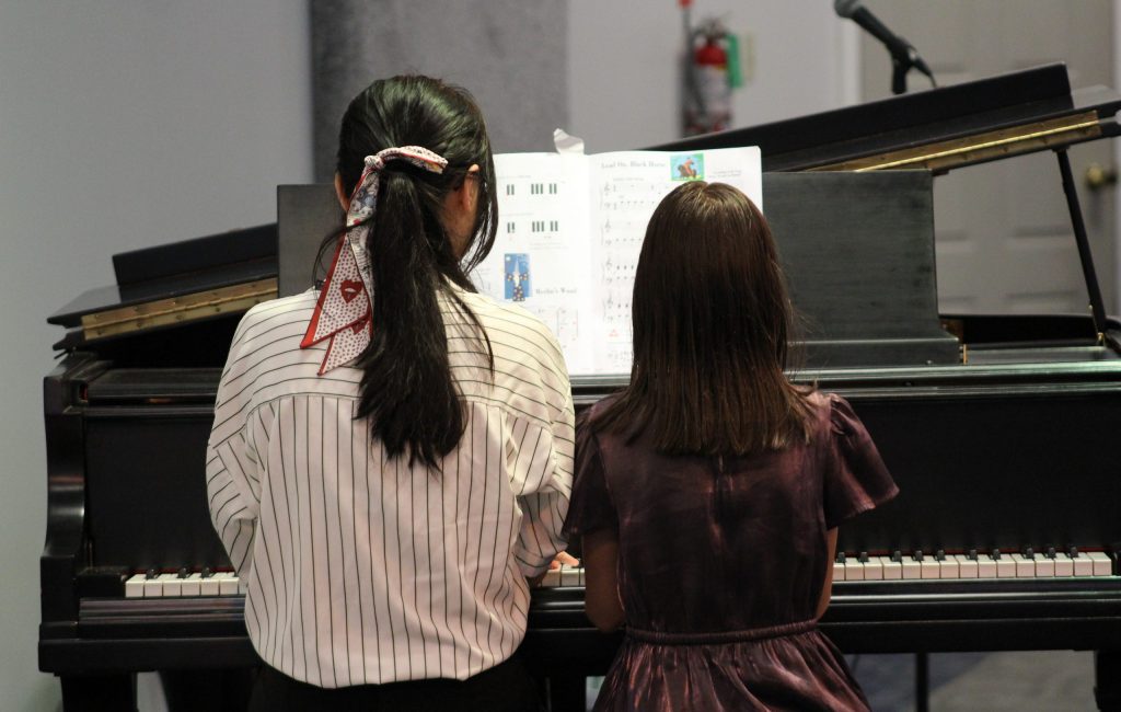 Piano teachers and piano students enjoy playing duets together in class to learn ensemble skills in a supportive environment.