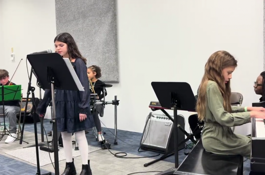 Children ages 6-12 playing instruments in a recital at Chambers Music Studio in Columbus, Ohio.